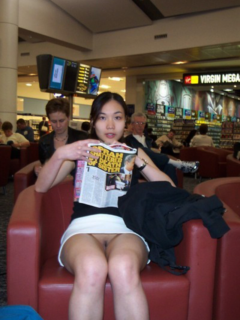 pic of Raquel with a reare sneak peak of a trimmed asian bush near the duty free area